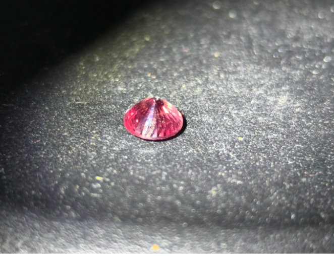 GS-000001 — 0.65 ct owner-described Padparadscha Sapphire, side view